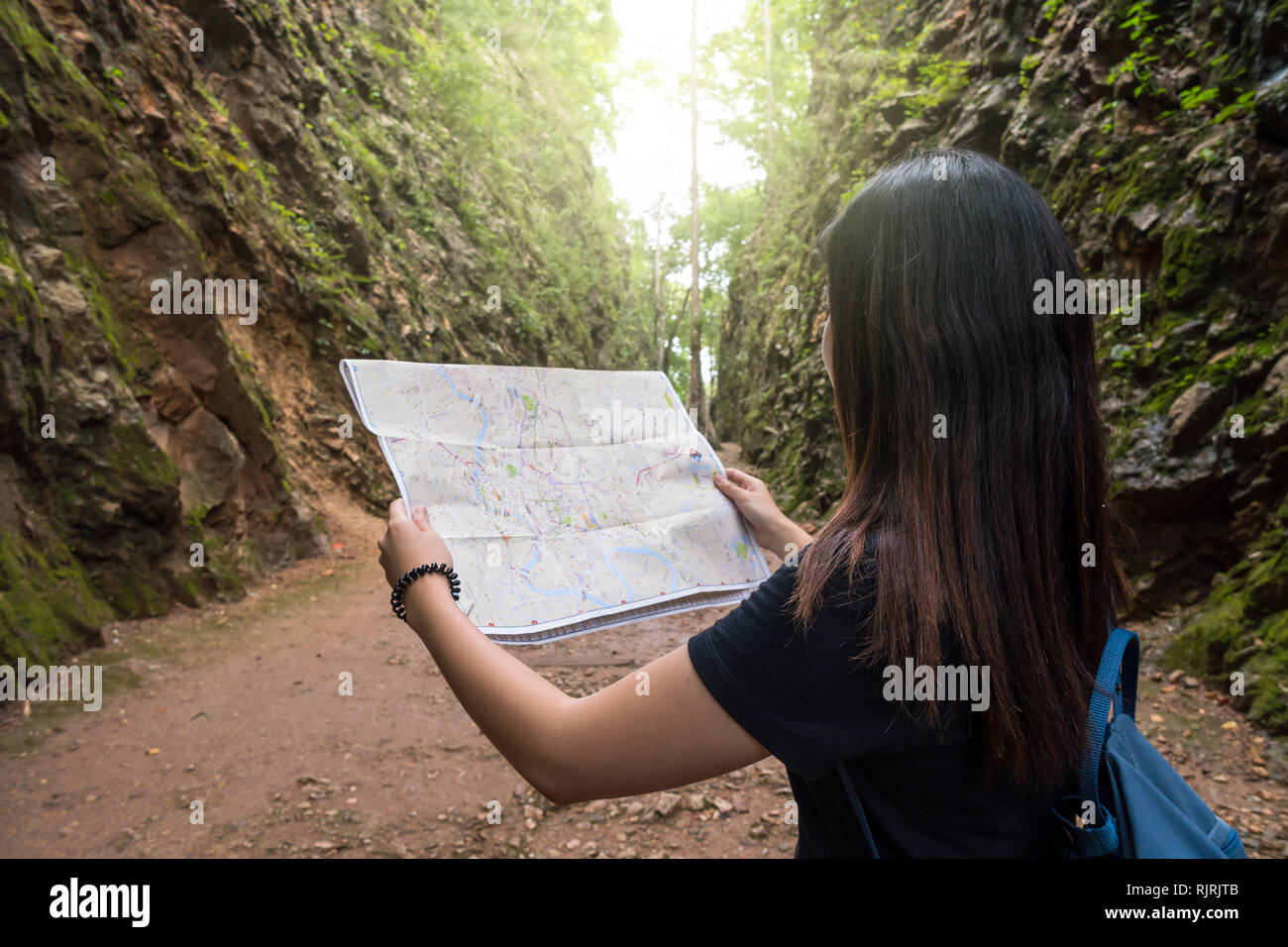 L'arrière de la jeune voyageuse voir la carte dans la forêt profonde, l'enfer à Kanchanaburi, Thaïlande, Voyage et transport concept Banque D'Images