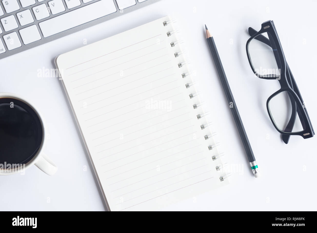 Bureau blanc bureau avec ordinateur portable, smartphone et autres fournitures de travail avec une tasse de café. Vue supérieure avec espace pour copier le texte d'entrée. Espace créateur Banque D'Images