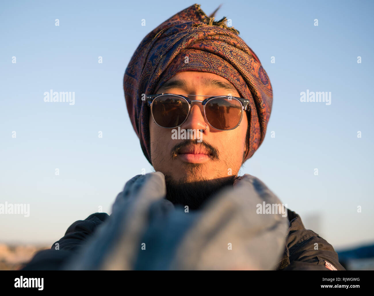 Jeune homme avec des dreadlocks touristiques barbu et foulard sur la tête  s'amusant à Essaouira, Maroc, à l'heure du coucher du soleil le soir Photo  Stock - Alamy