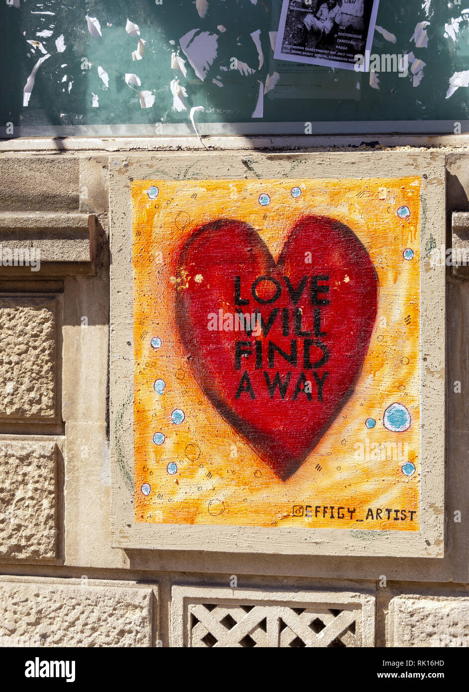 Peinture murale en forme de coeur par effigie artiste avec l'amour trouvera un moyen a écrit à l'intérieur Banque D'Images