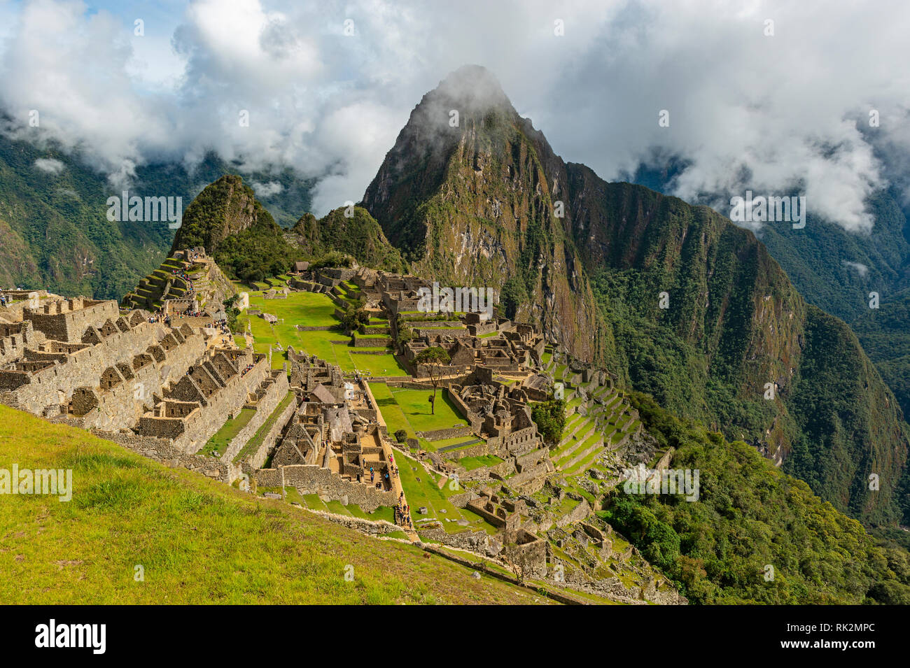 La ruine Inca de Machu Picchu brouillard le matin avec son livre vert sur le terrain en terrasses et Huayna Picchu pic dans le fond près de Cusco, Pérou. Banque D'Images
