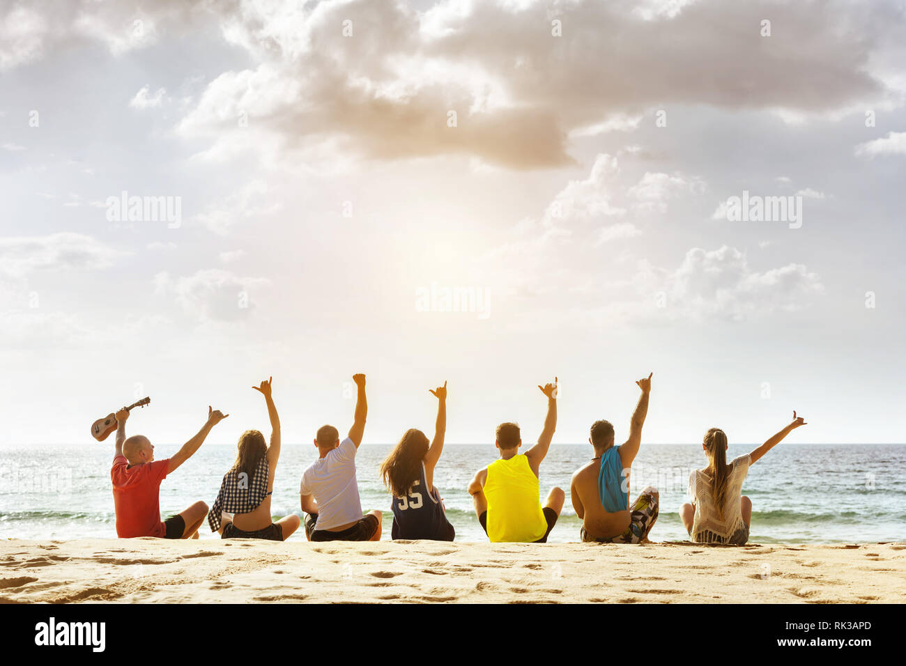 Groupe d'happy friends having party au coucher du soleil mer plage. Un espace réservé au texte Banque D'Images