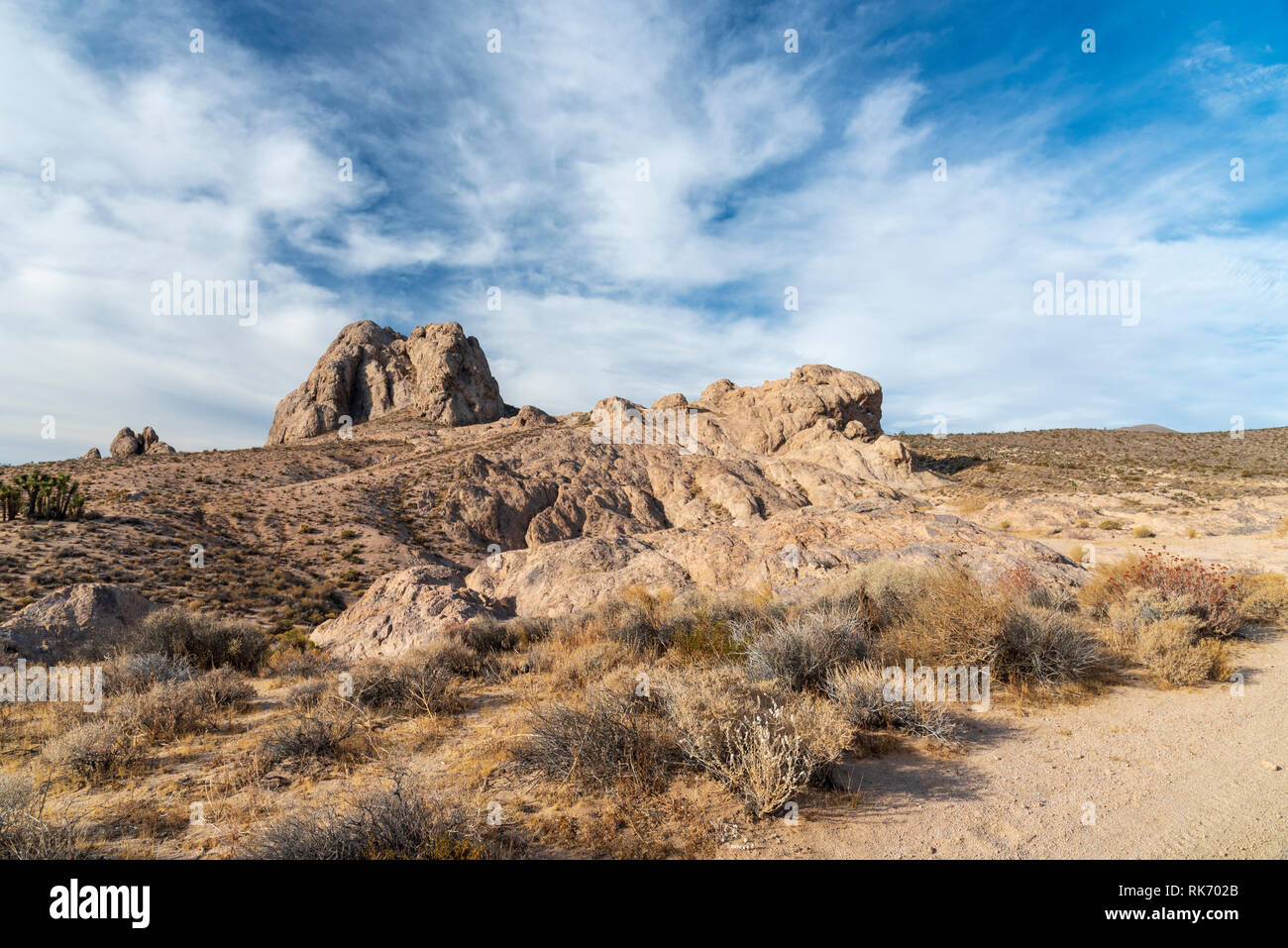 Paysage désertique avec des formations rocheuses sous ciel bleu ciel avec des nuages blancs. Banque D'Images