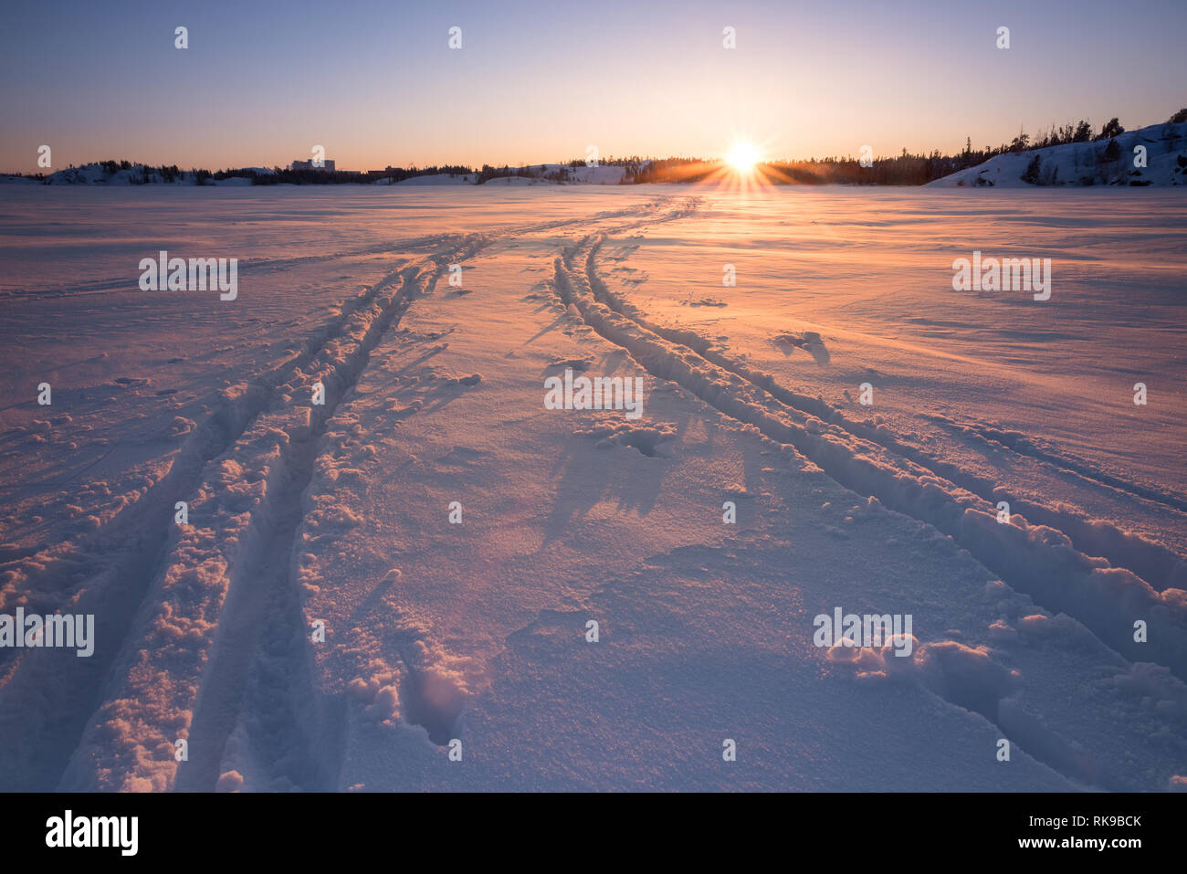 Pistes de ski de fond au coucher du soleil sur le lac Frozen Frame à Yellowknife, Territoires du Nord-Ouest, Canada. Banque D'Images