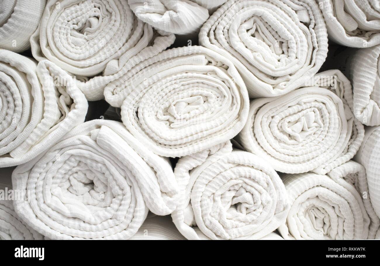Des tonnes de couvre-lits en coton blanc roulé. Libre. Banque D'Images