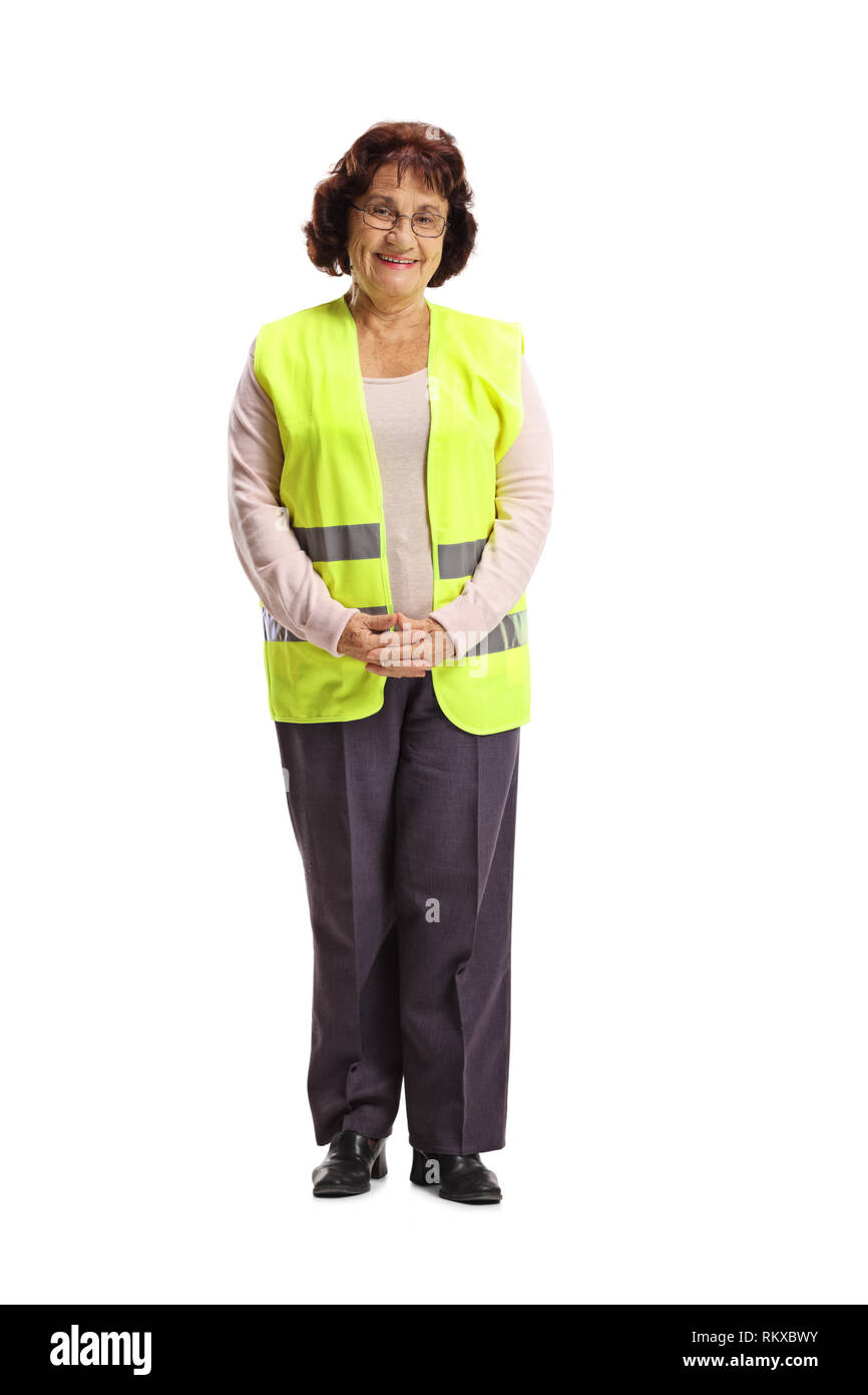 Full Length portrait of a senior woman avec un gilet de sécurité smiling at the camera isolé sur fond blanc Banque D'Images