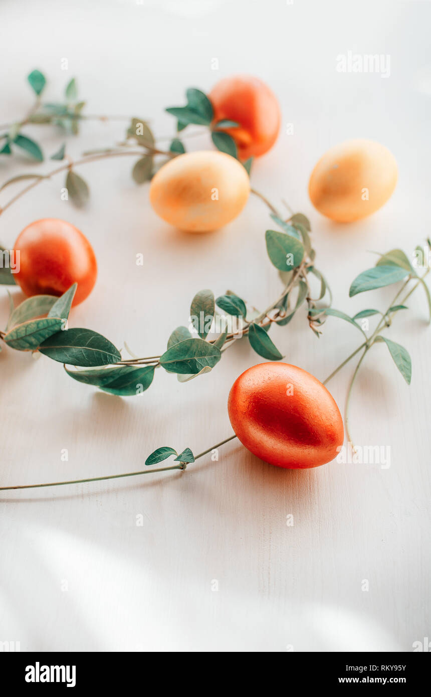 Oeufs multicolores sur fond blanc. Pâques créatif concept. Corail vivant - la couleur de l'année 2019 Banque D'Images