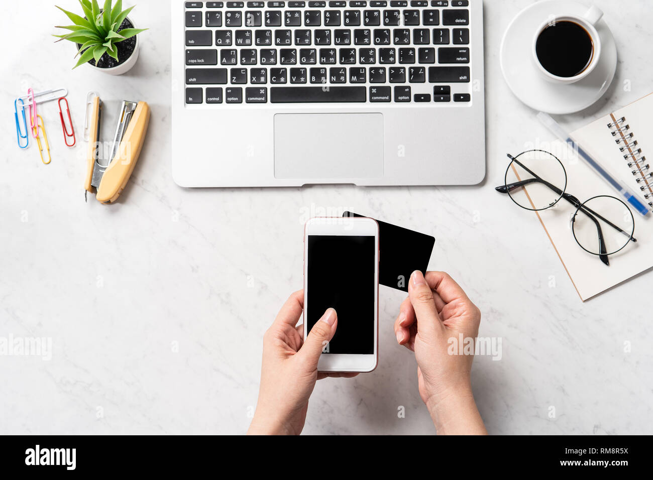 Une femme est en train de faire un achat en ligne, des maquettes et de carte de crédit sur téléphone cellulaire mobile office bureau isolé sur fond en mode copie, spac Banque D'Images