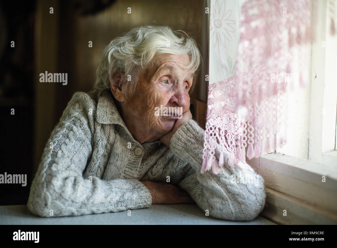 Vieille Femme Aux Cheveux Gris Et Regarde Par La Fenêtre
