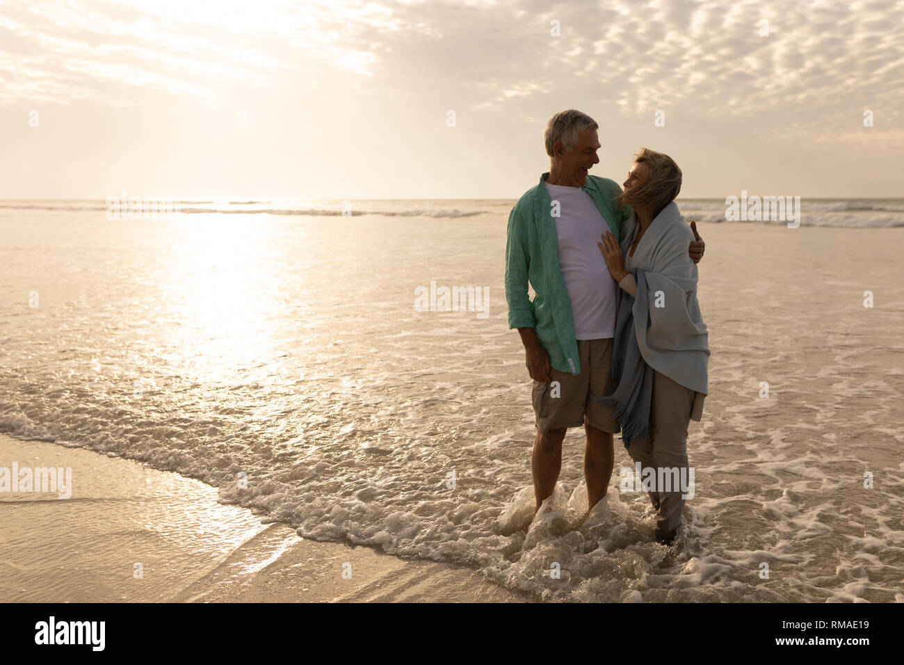 Senior couple enlacés sur la plage Banque D'Images