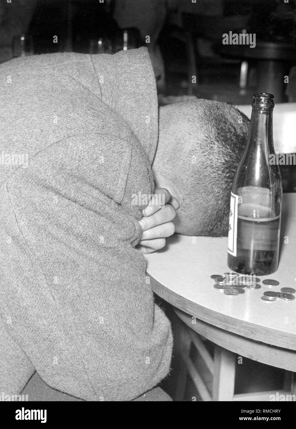 Le dernier invité, un jeune GI américain, prend une sieste au bar le tableau, la demi-bu de la bière et la bouteille de changement sont à côté de lui. Scène dans la Melodie bar dans Senefelderstrasse à Munich. Banque D'Images