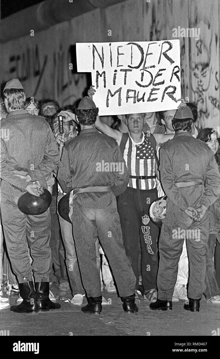 Bloc de gardes-frontières de la RDA les manifestants pendant une manifestation contre le mur de Berlin sur le 25e anniversaire de sa création, le point de passage des Alliés Checkpoint Charlie dans le quartier de Kreuzberg. Banque D'Images