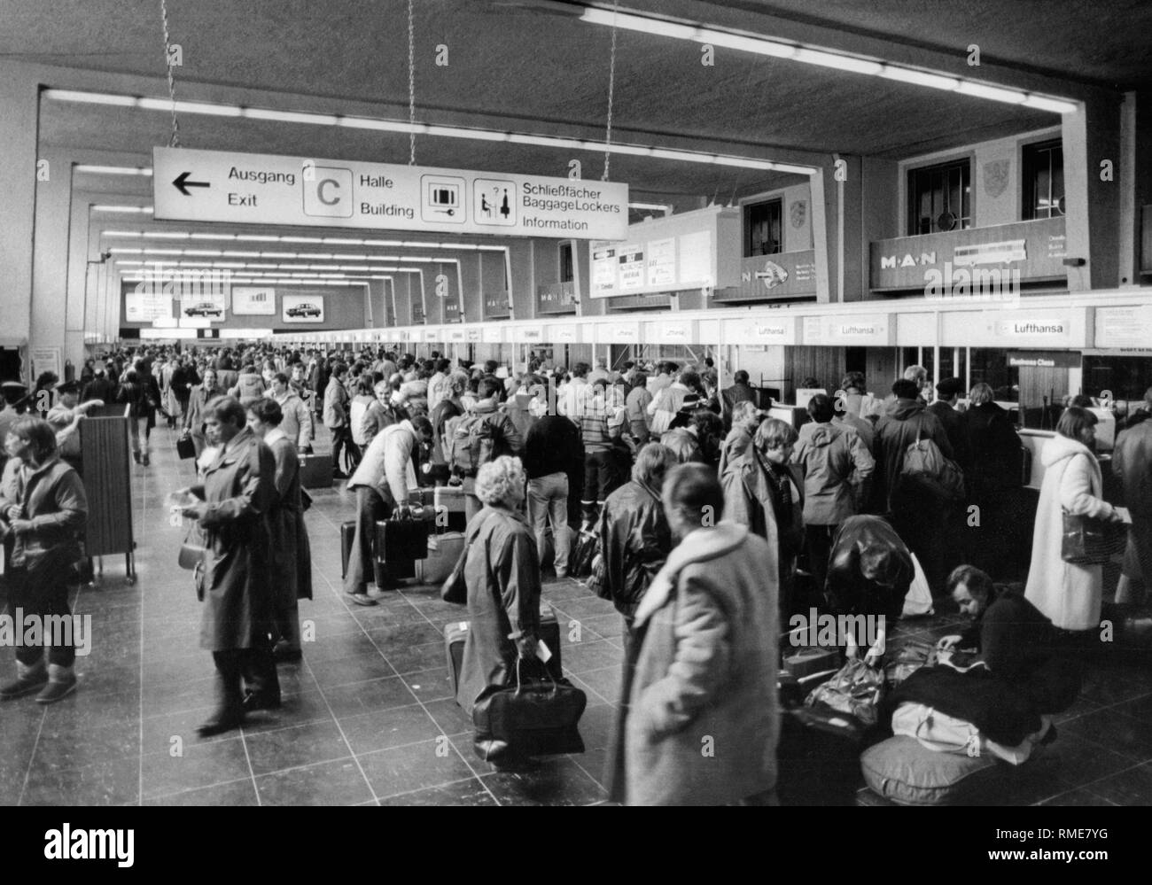 Les passagers d'attendre dans de longues lignes à l'arrivée dans une des salles de l'aéroport de Munich à Riem. Banque D'Images