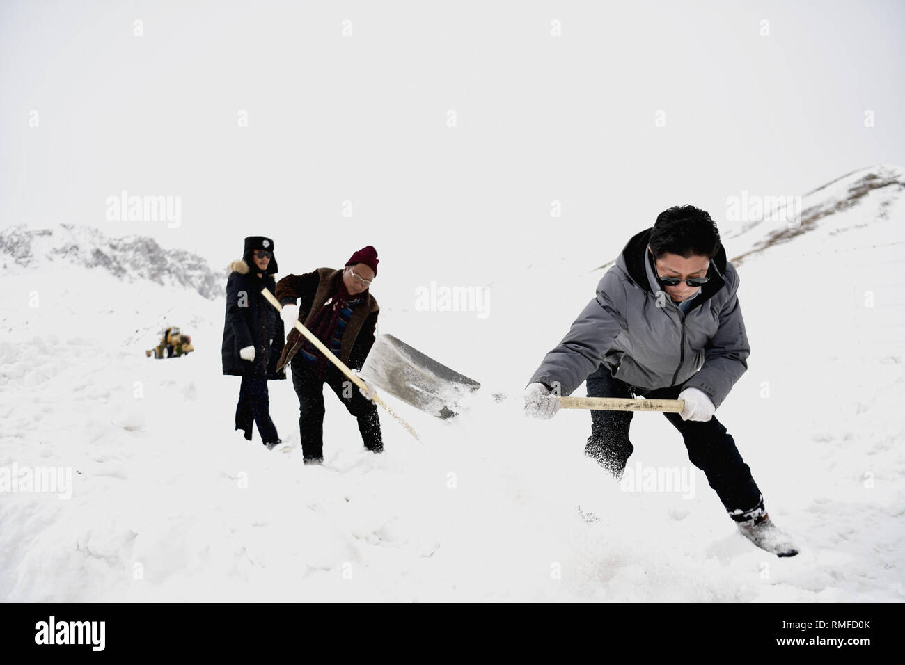 Yushu, dans la province de Qinghai en Chine. Feb 14, 2019. Les gens la neige propre dans Zhaqing Zaduo ville du comté de la préfecture autonome tibétaine de Yushu, dans la province de Qinghai en Chine, le 14 février 2019. Après des jours de tempêtes de neige, les routes dans de nombreux domaines de la préfecture autonome tibétaine de Yushu sont couverts sous la neige jusqu'à 45 centimètres. L'autorité locale d'Zaduo a envoyé 37 grandes machines pour le blizzard les zones les plus touchées pour effacer les routes couvertes de neige. Credit : Zhang Long/Xinhua/Alamy Live News Banque D'Images