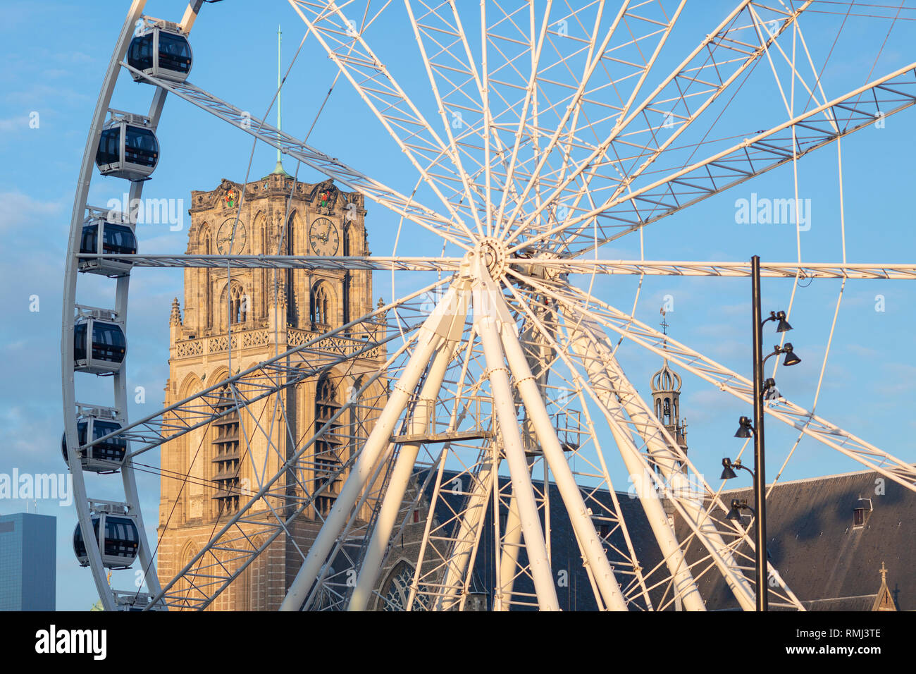 La grande roue dans le centre-ville de Rotterdam, aux Pays-Bas avec en arrière-plan vue à travers les rayons l'église principale de la ville de la tour Banque D'Images