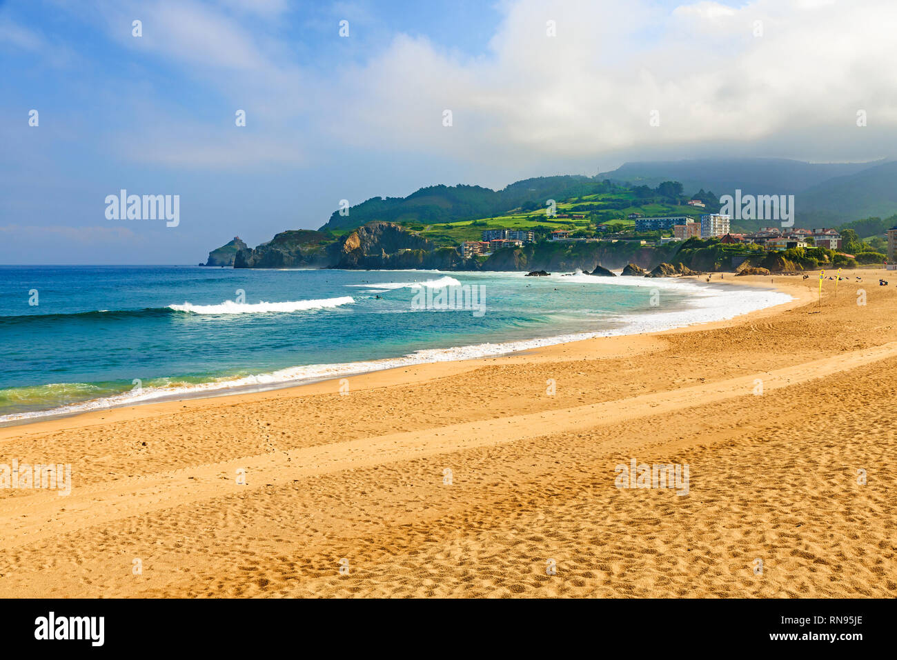 Vue sur plage de sable en Bakio, Pays Basque, Espagne avec des vagues et des surfeurs Banque D'Images
