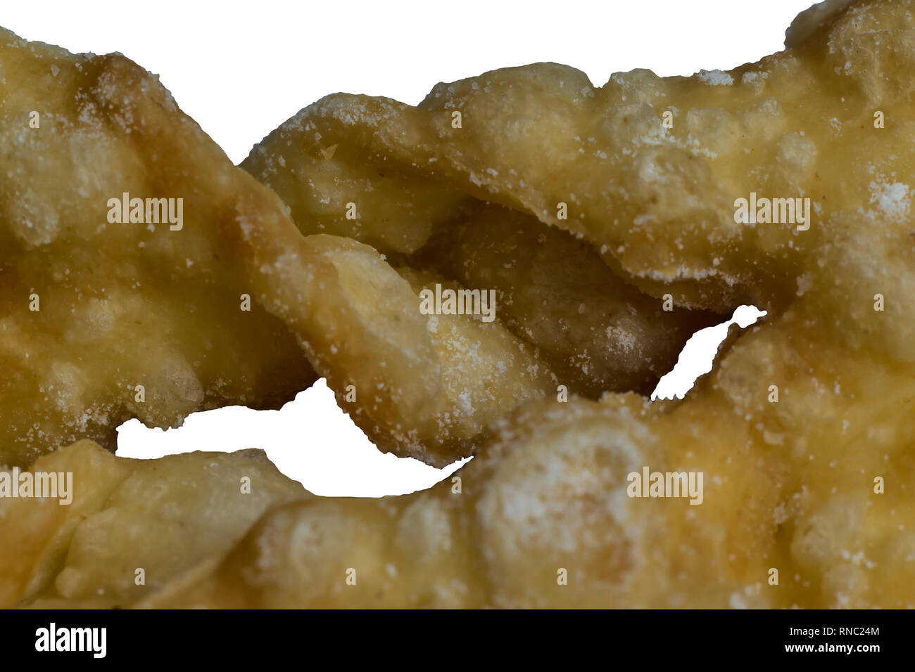 Macrophoto.dessert européen d'ailes d'ange. Texture intéressante de bandes de pâte frits avec avec un trou au milieu. Sur le site des pâtisseries, des bonbons. Banque D'Images