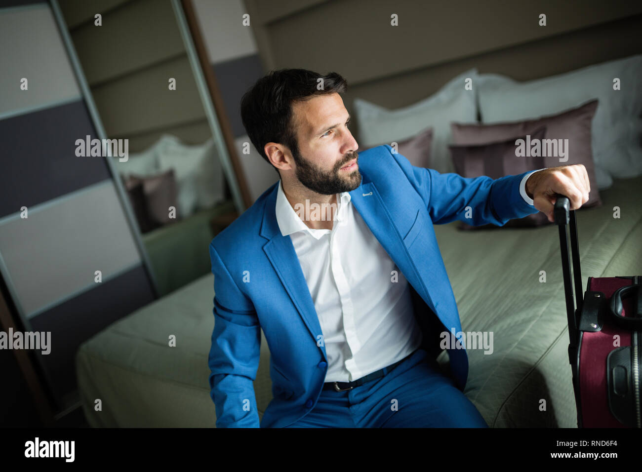 Portrait of handsome businessman in hotel room Banque D'Images