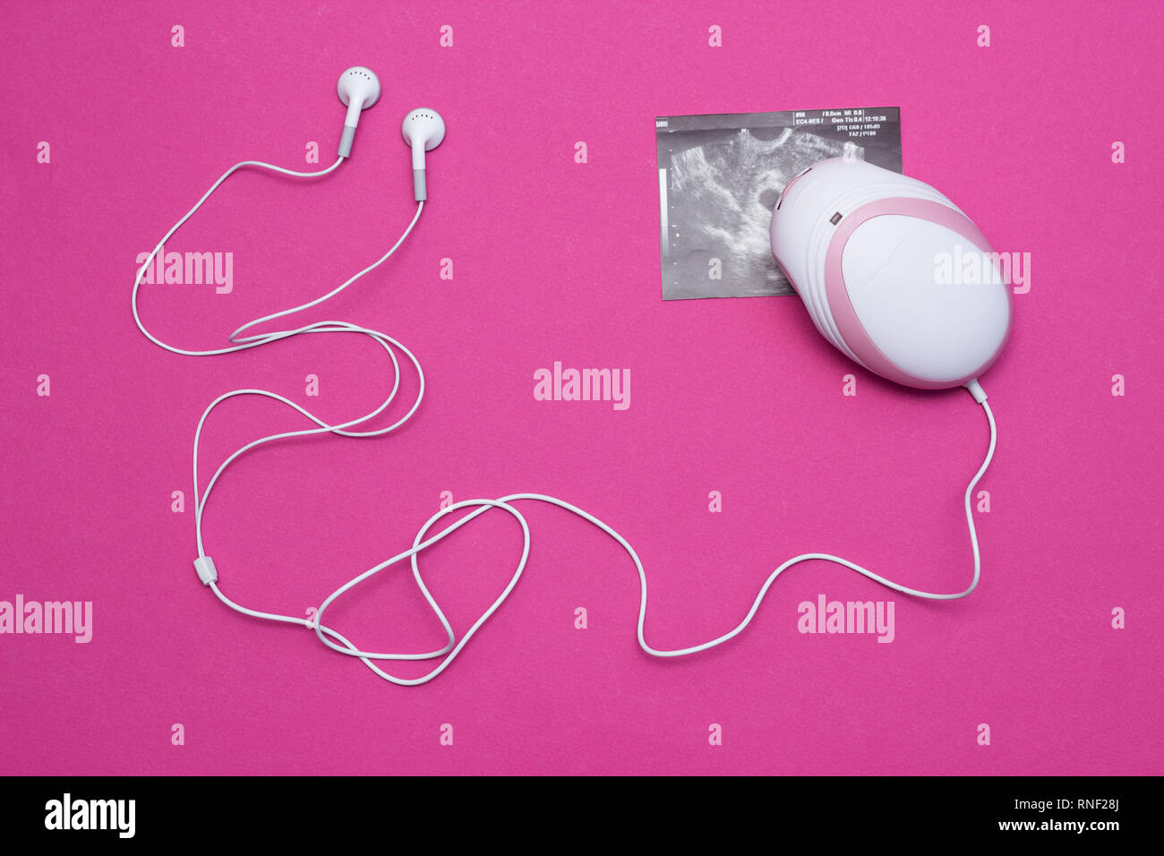 Doppler foetal avec écouteurs pour écouter le rythme cardiaque du bébé chez  les femmes enceintes et une photo de l'échographie de la grossesse,  close-up, rose bac Photo Stock - Alamy