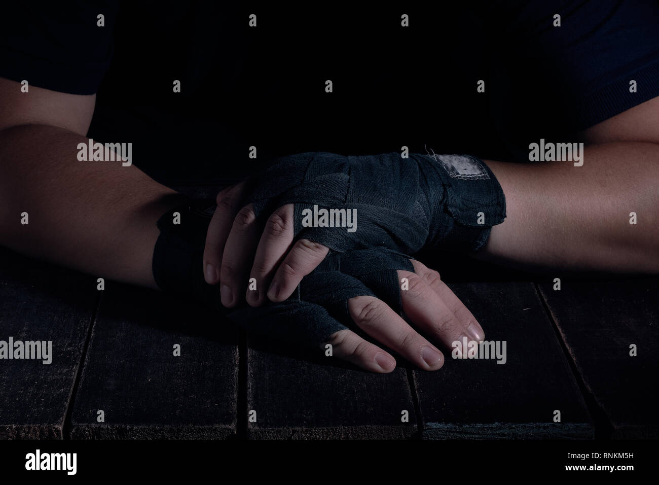 Mains de fighter dans un style moderne sur fond noir. Concept de soins de santé. Corps musculaire remise en forme. Mode de vie sain. Fond sombre. Banque D'Images