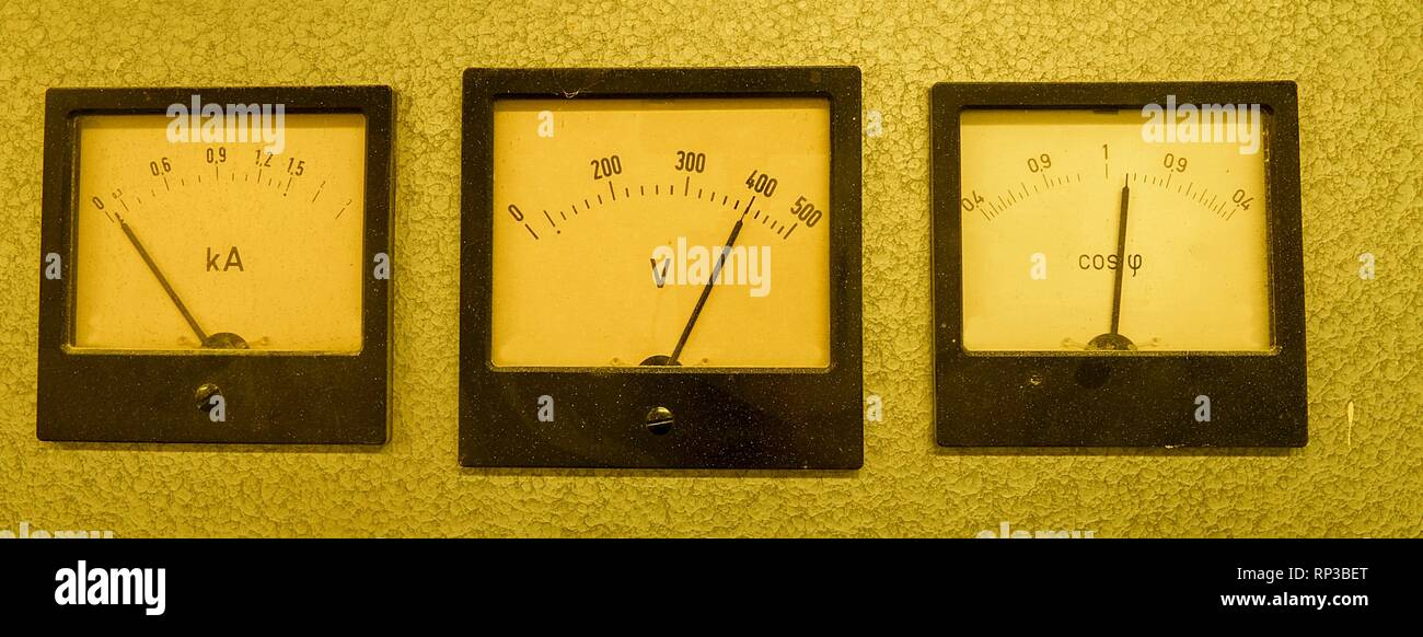 Trois anciens instruments analogiques - facteur de puissance multimètre, Voltmètre et ampèremètre isolé sur fond gris. Banque D'Images