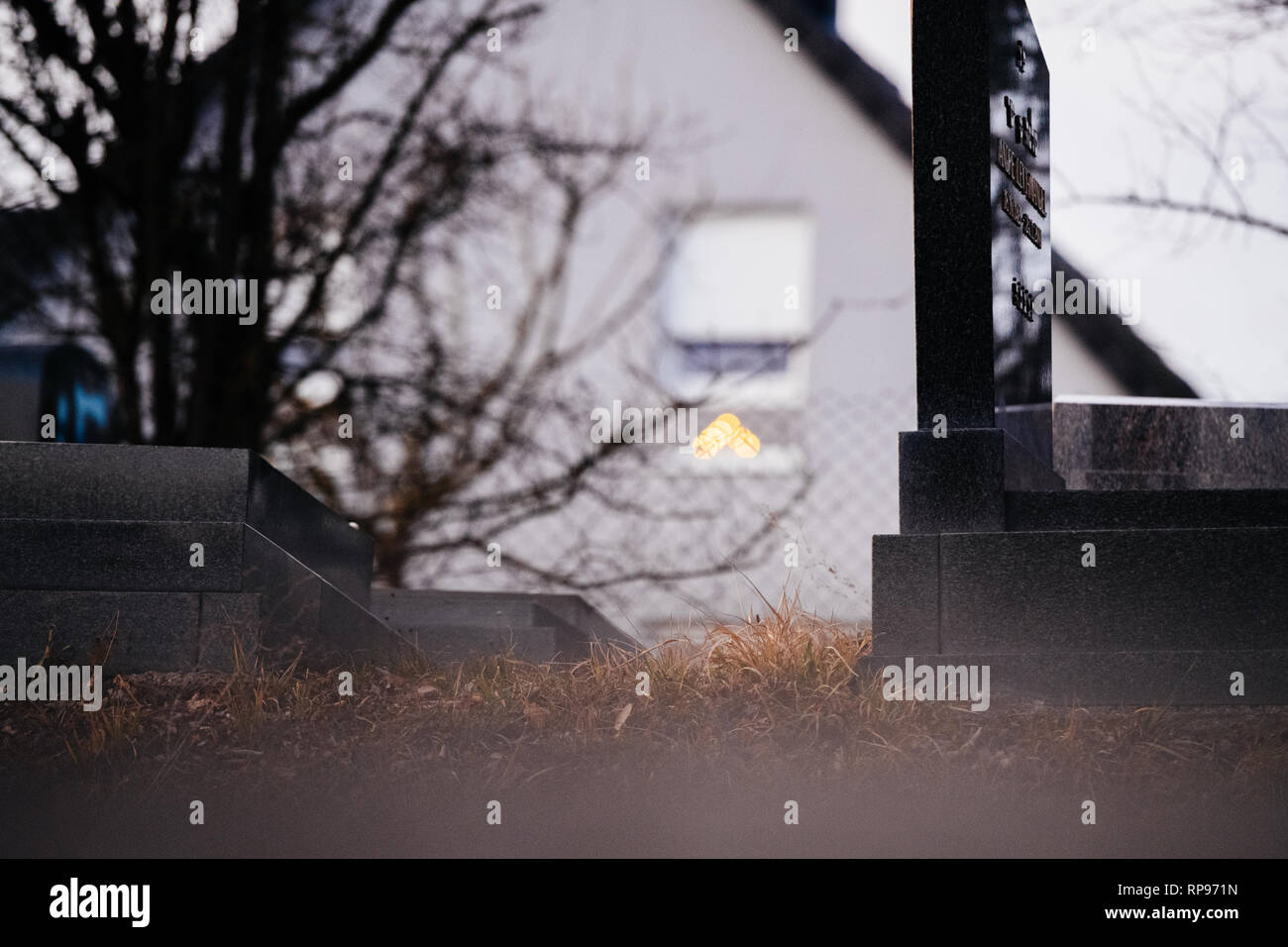 Bokeh Menorah silhouette dans la fenêtre d'une maison près de l'objet d'actes de vandalisme graves avec des symboles nazis en bleu peint sur les tombes endommagées - cimetière juif à Quatzenheim près de Strasbourg . Banque D'Images