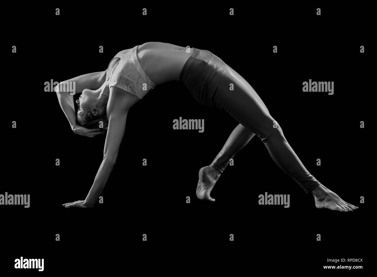 Woman practicing yoga, 'Wild Thing' poser en studio, noir et blanc Banque D'Images