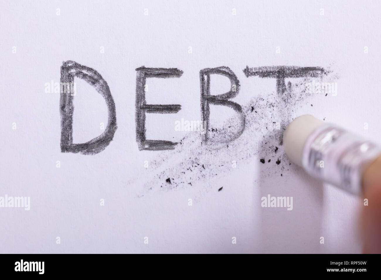 Close Up De Gomme A Effacer Mot De La Dette Sur Papier Blanc Photo Stock Alamy