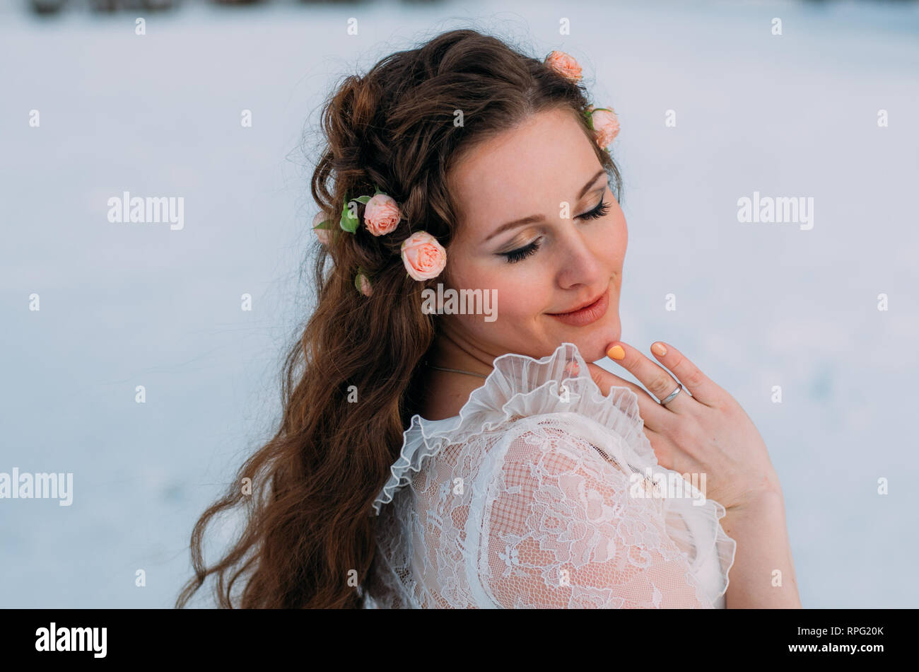 Portrait de mariée en hiver avec des roses dans les cheveux Banque D'Images