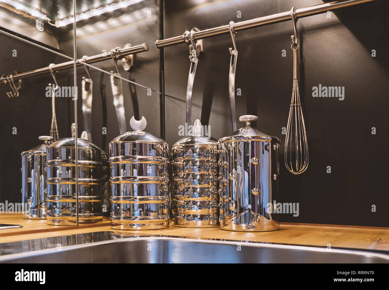 Vue en gros plan de cuisine en acier inoxydable storage jars et ustensiles sur une étagère Banque D'Images