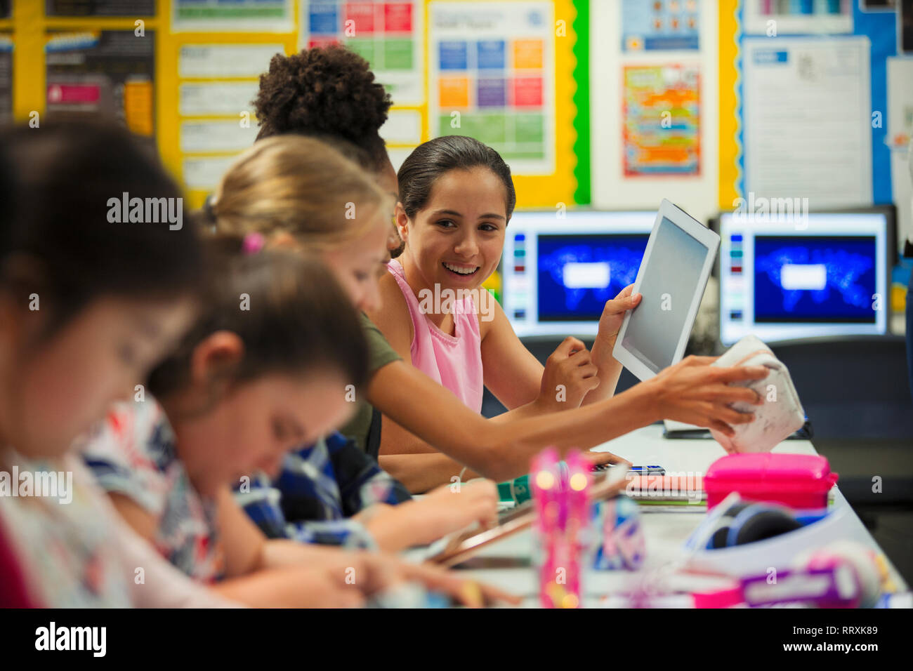 Junior High school girl étudiants using digital tablet in classroom Banque D'Images