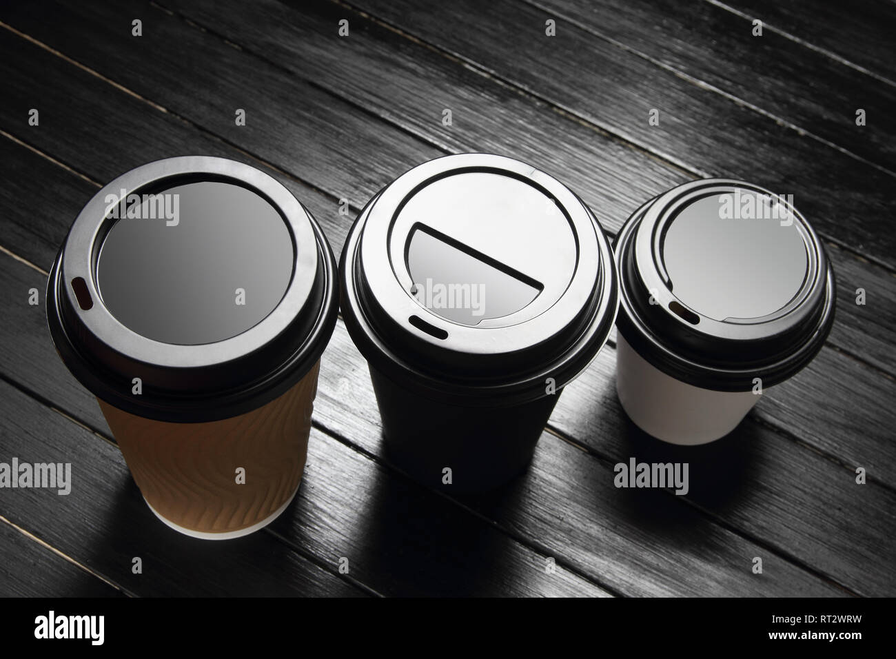 Tasses à café jetables sur fond de bois Banque D'Images