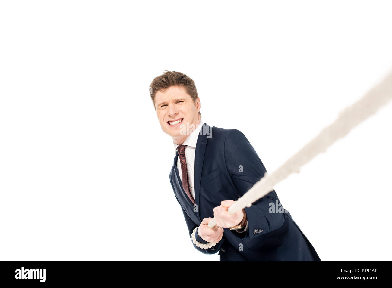 Young businessman pulling rope isolated on white Banque D'Images