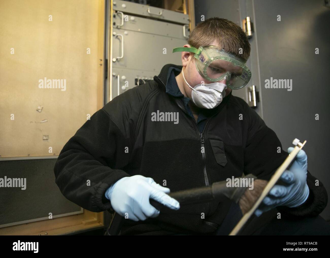 NEWPORT NEWS, Virginie (janv. 30, 2019) pompier-électricien Jordanie Redd, de Connorsville, Indiana, affectés à l'USS Gerald R. Ford (CVN 78) Ministère de l'air, les vides d'un filtre dans un système de lancement d'avions électromagnétique (EMALS) prix. Ford est actuellement en post-shakedown la disponibilité de Huntington Ingalls Industries-Newport News Shipbuilding. Banque D'Images