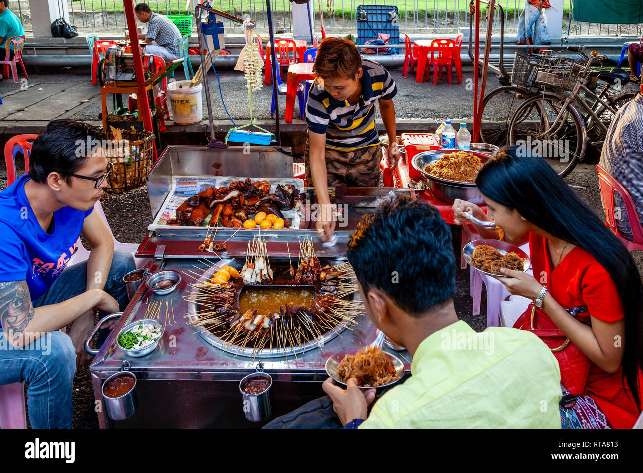 Les jeunes de manger des aliments de Rue, Yangon, Myanmar Banque D'Images