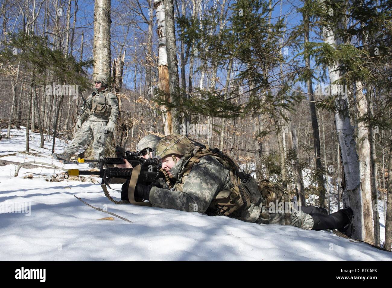 Le capitaine de l'armée américaine James D'Andrea, gauche, commandant de compagnie, la Compagnie Alpha, 572nd bataillon du génie de la Brigade d'infanterie, 86e Brigade Combat Team (montagne), Washington Garde nationale, observe comme 1er lieutenant Christopher Devito, centre, un chef de section, et le sergent. Daniel Hart, un ingénieur de combat, recon une violation possible du camp sur le site de formation d'Ethan Allen, Jericho, Vermont), 9 févr. 2019. Les sapeurs ont participé à un événement de formation dans lequel elles ont violé un obstacle, à l'aide d'un dispositif de charge de Bangalore, la création d'une voie sûre pour l'infanterie à passer à travers. Banque D'Images