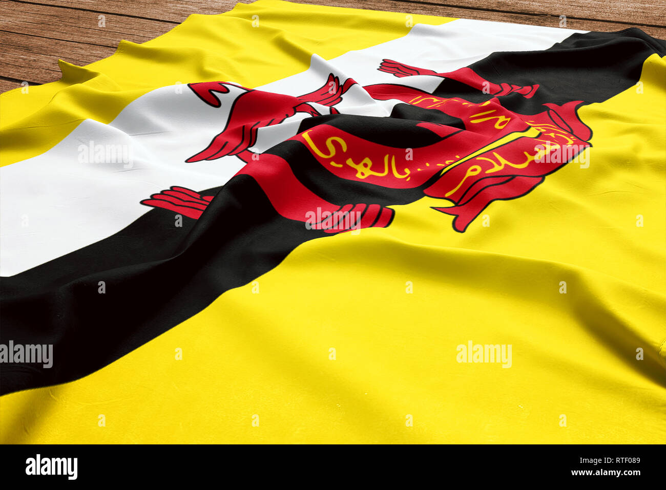 Pavillon de Brunéi sur un bureau en bois. Drapeau brunéien soie vue d'en haut. Banque D'Images