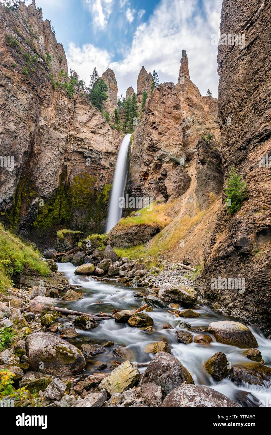 Cascade s'écoule à travers le paysage érodé avec aiguilles de roche, Tour Tour de l'automne avec Creek, Parc National de Yellowstone, Wyoming, USA Banque D'Images