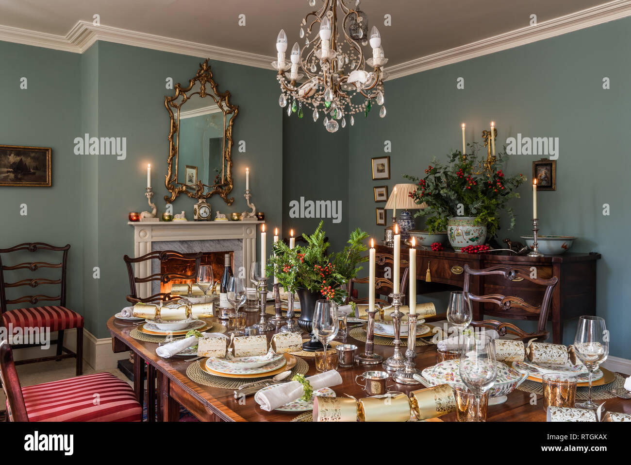 Table de salle à manger en acajou et géorgienne bahut avec des chaises capitonnées de Regency stripe avec cheminée en anglais Banque D'Images
