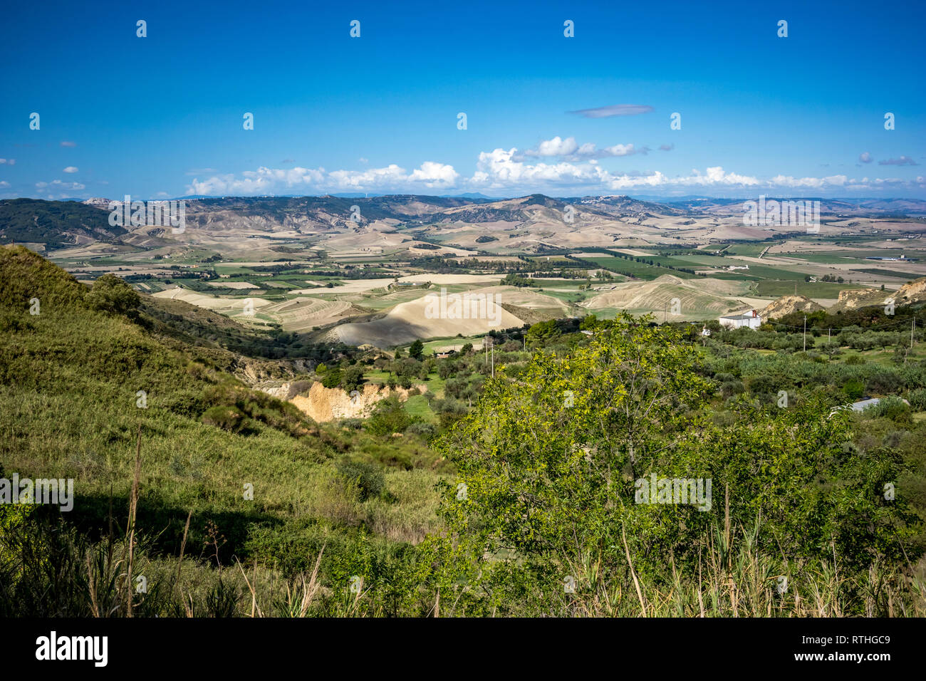 Valley paysage campagnard, Basilicate, Italie, journée ensoleillée, Green Hills et ciel bleu clair, de troubles de l'énergie éolienne éoliennes loin dans le background Banque D'Images