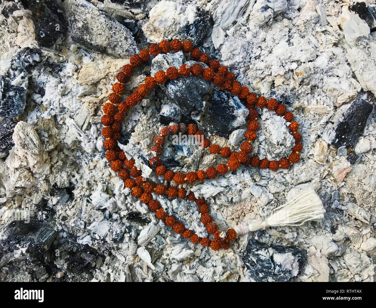 Rosaire chapelet sur les cendres de fond de cendre. Rudraksha. Mala. Mantra. 108 perles. Banque D'Images