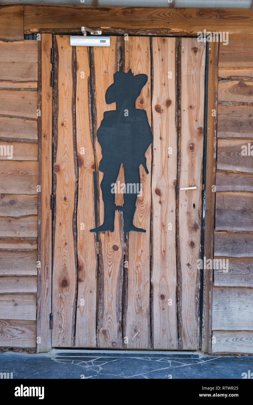 Les toilettes pour hommes avec des silhouettes de cowboy Banque D'Images