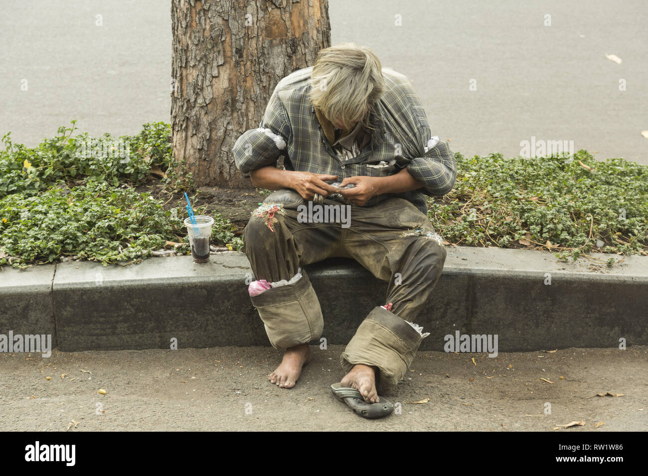 Homme sans domicile à Ho Chi Minh, Vietnam Banque D'Images