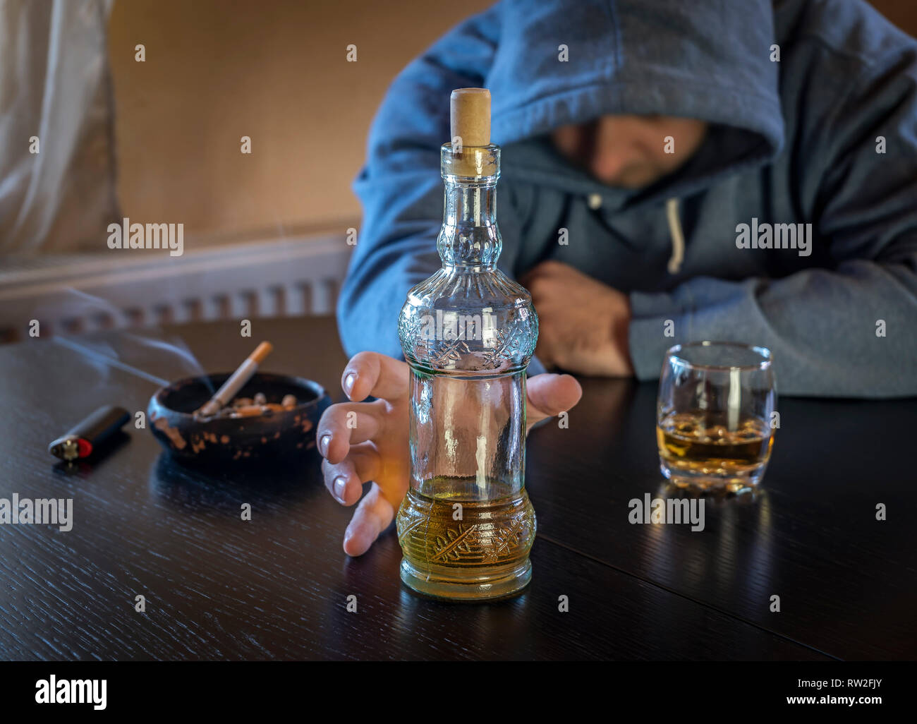 L'alcool et de la cigarette un toxicomane fournit une part à la bouteille Banque D'Images