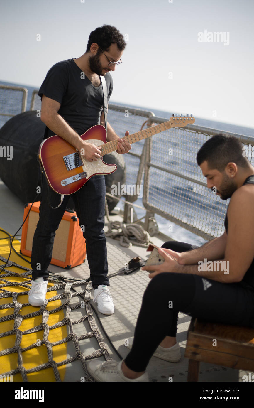 Bande libanais Mashrou' Leila mis en place et se préparent à enregistrer une chanson à bord du navire de Greenpeace Rainbow Warrior sur le Soleil nous unit d', de la Méditerranée, le 23 octobre 2016. N38°01,545' E9°45,487' Banque D'Images