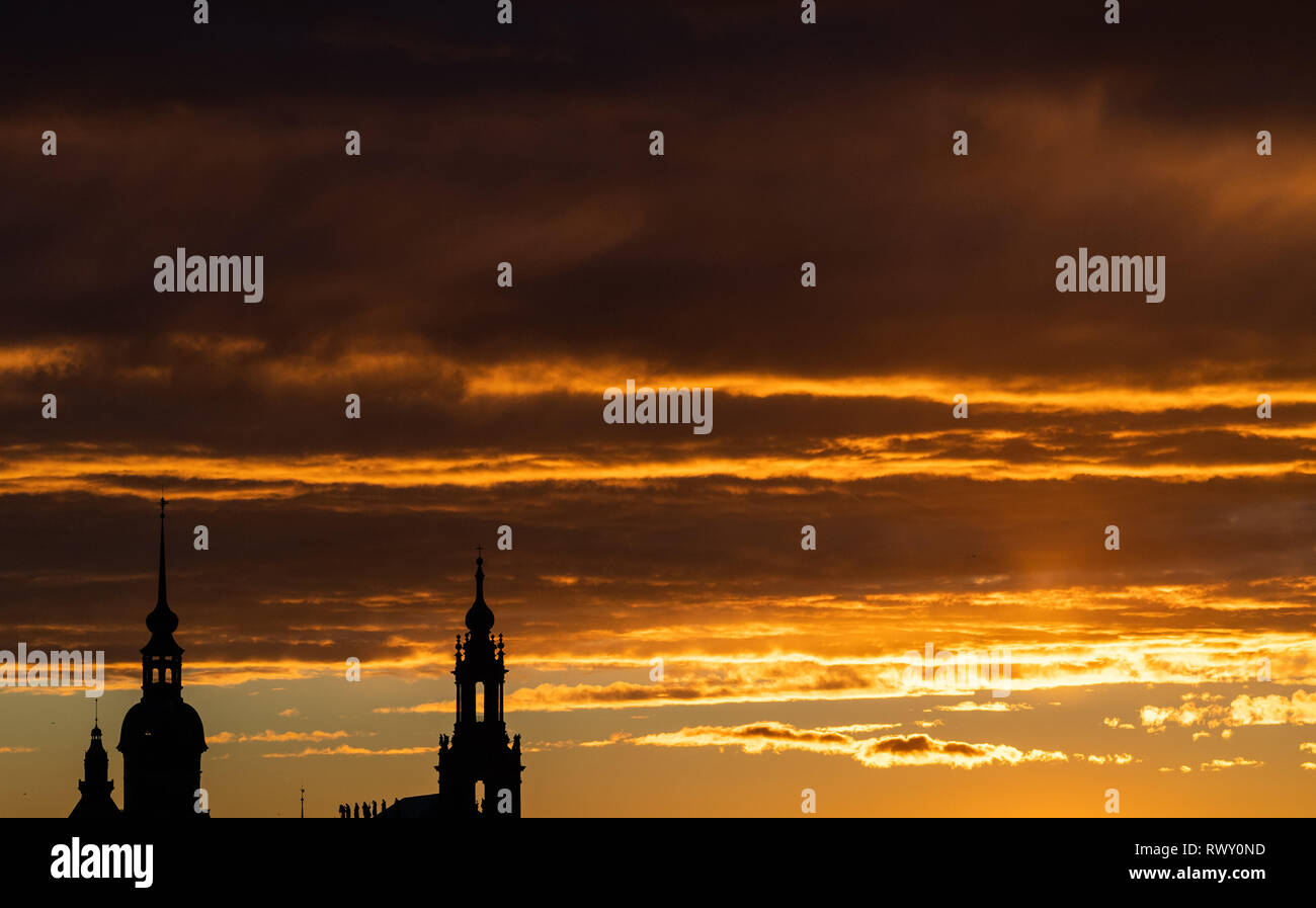 Dresde, Allemagne. 07Th Mar, 2019. Le soleil se couche derrière la tour de l'église de la Cour Catholique (r) et la tour du château de Dresde de Hausmann. Crédit : Robert Michael/dpa-Zentralbild/ZB/dpa/Alamy Live News Banque D'Images