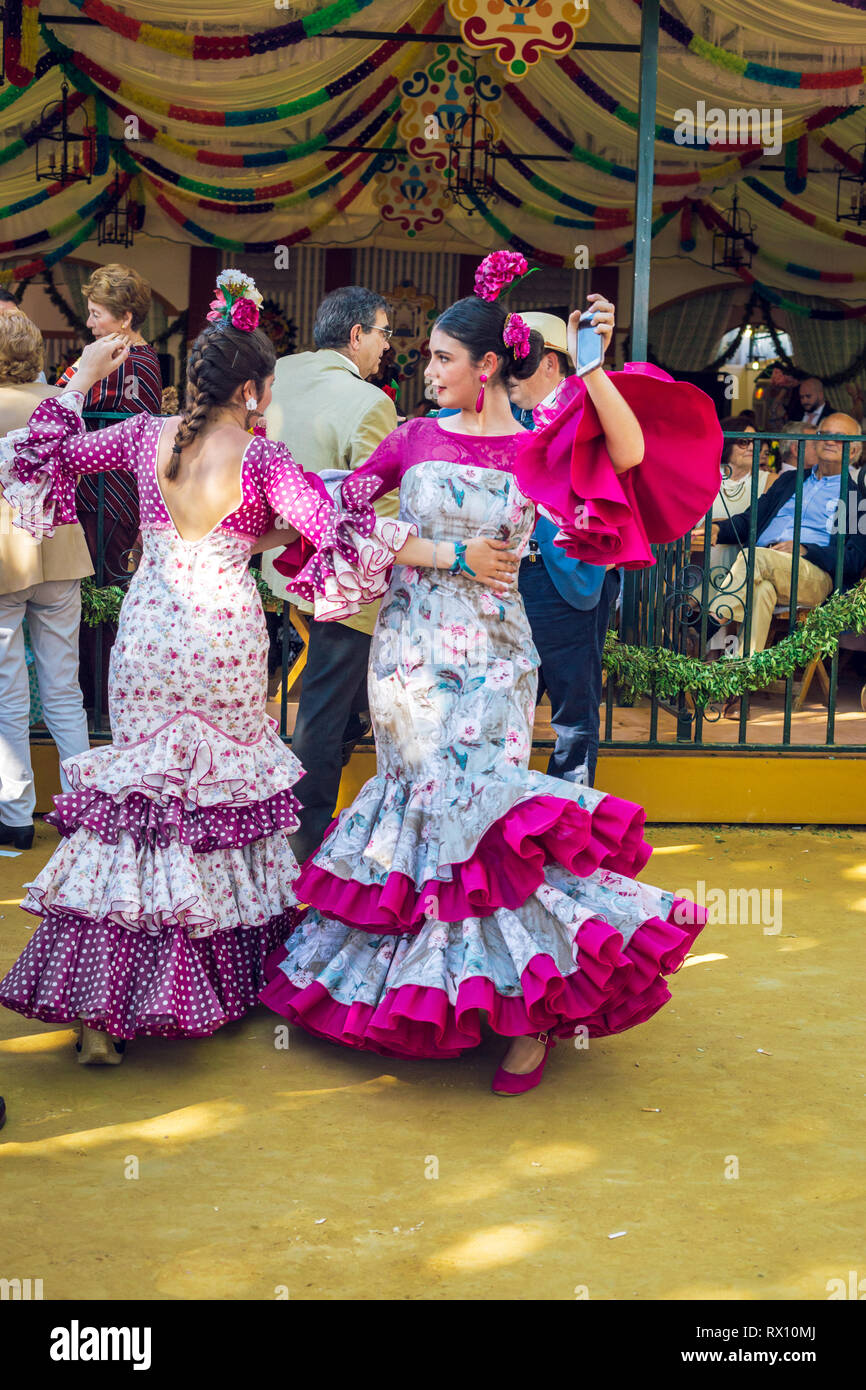 Les jeunes femmes portant des robes de flamenco et de danse 'Sevillanas' à la foire d'avril, Foire d'Avril de Séville (Feria de Séville). Banque D'Images
