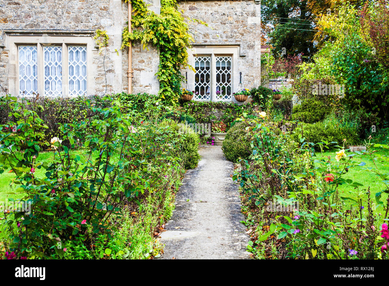 Le jardin de devant d'un cottage en pierre dans la région des Cotswolds, en Angleterre. Banque D'Images