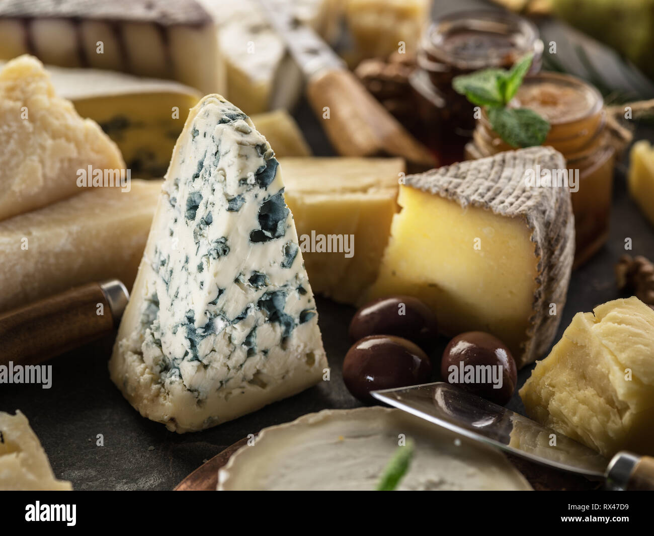 Segment de moisissure bleue fromage avec olives et gamme de fromages à l'arrière-plan. Banque D'Images