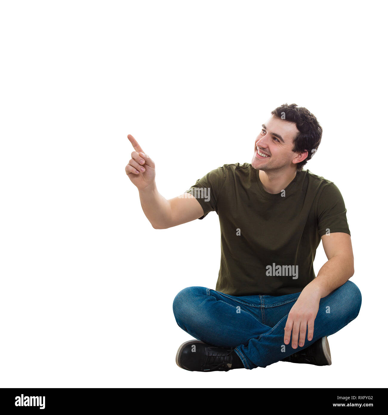 Handsome young man wearing jean décontracté et t-shirt, assis sur le sol les jambes croisées détendue, en pointant l'index up smiling isolated over Banque D'Images